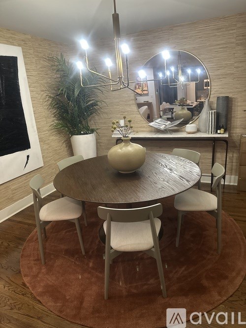 A modern dining room with a round table and chairs.