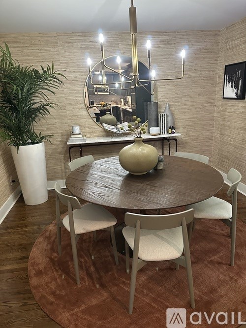 A dining room with a round table and chairs.