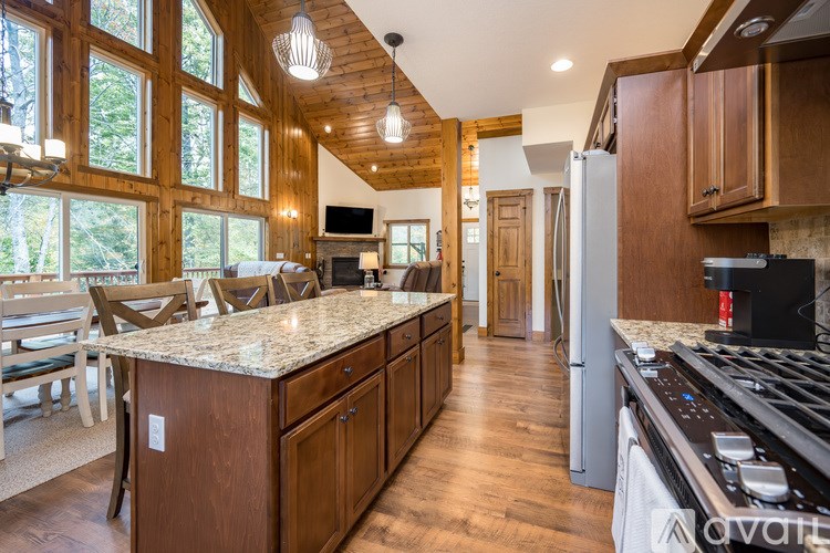 A kitchen with wooden cabinets and a large island.