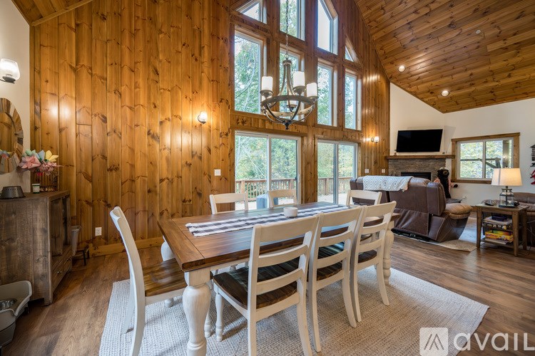 A wooden dining room with a table set for four.