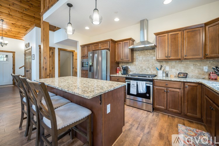 A kitchen with wooden cabinets and a granite countertop.