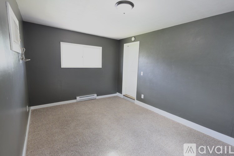 A room with grey walls and a white door.