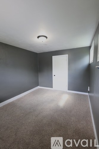 A room with grey walls and a carpeted floor.
