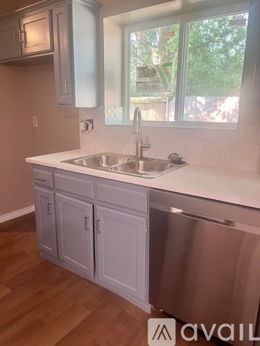 A kitchen with a sink and cabinets.