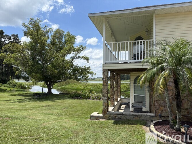 A house with a balcony overlooking a body of water.