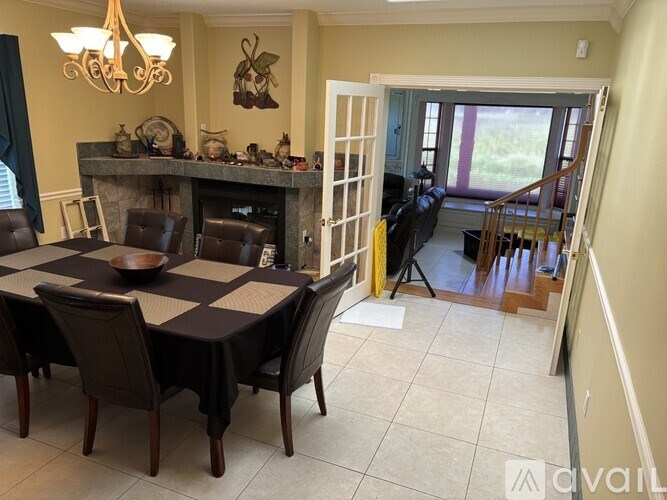 A dining room with a table set for six.