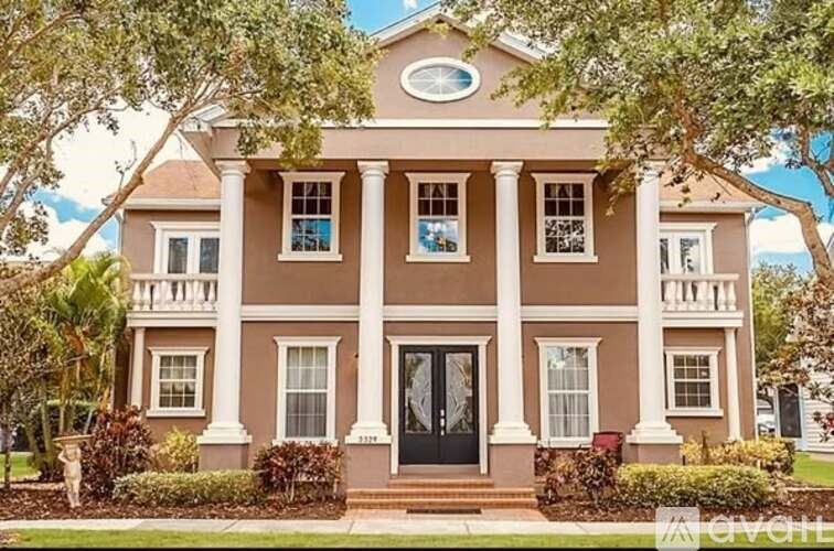 A large house with a black front door and white columns.