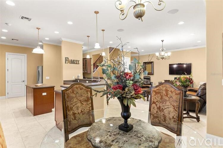 A dining room with a table set for four.
