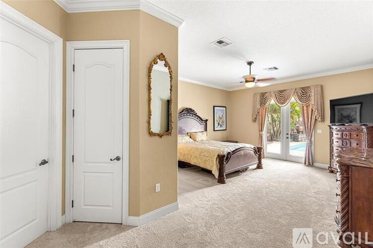 A bedroom with a bed, dresser, and mirror.