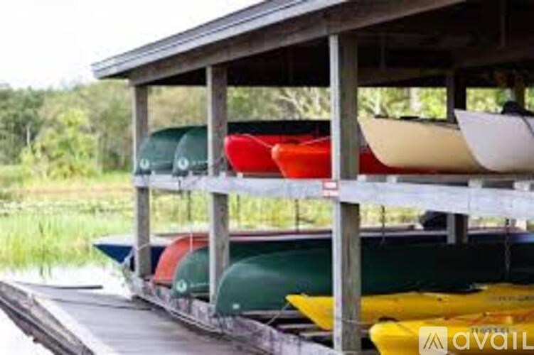 A row of boats are stored on a dock.