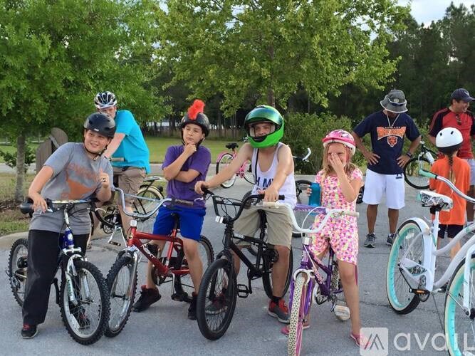 A group of people with bikes in a park.