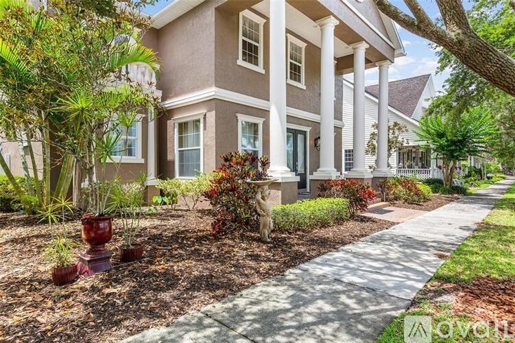 A house with a front yard and a sidewalk.