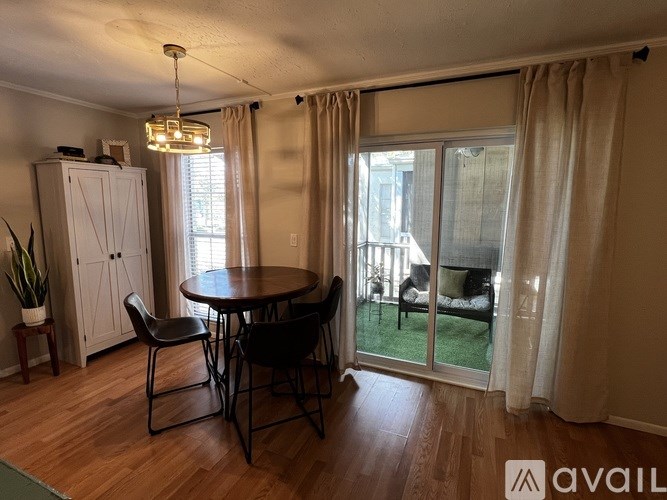 A dining area with a round table and chairs.