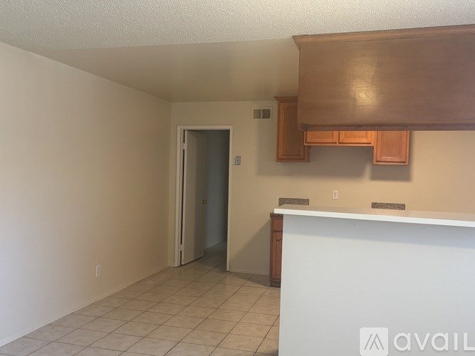 A room with a white counter and a brown cabinet.
