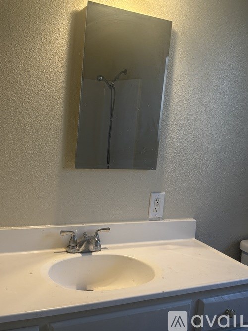 A bathroom sink with a mirror above it.