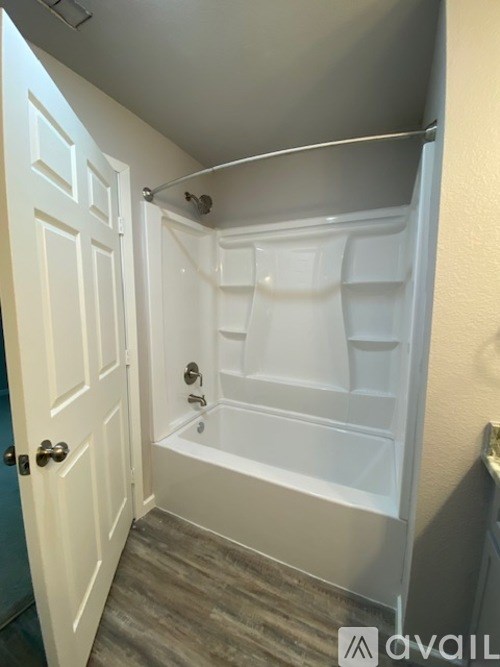 A small white bathroom with a walk-in shower.