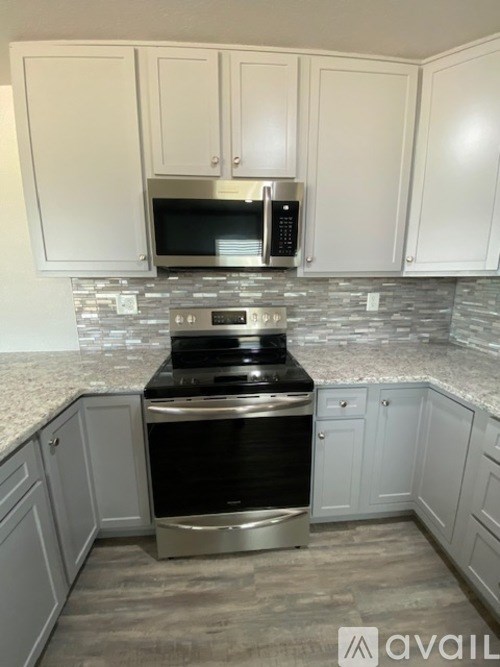 A kitchen with a stove top oven and microwave.