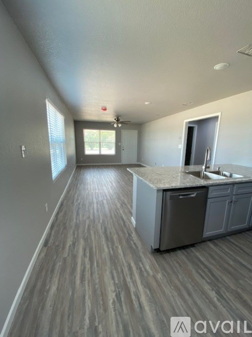 A kitchen area with a counter and cabinets.