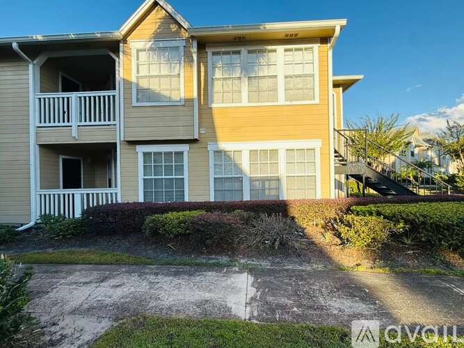 A two-story house with a balcony on the second floor.