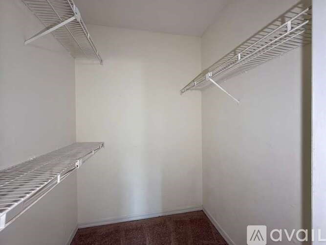 Empty room with two shelves on the wall.