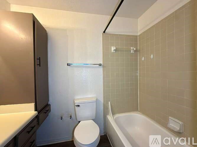 A bathroom with a toilet, sink, and bathtub.