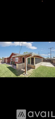 A house with a red brick exterior and a white roof.
