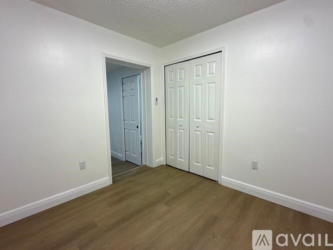 A room with a white door and a blue door.