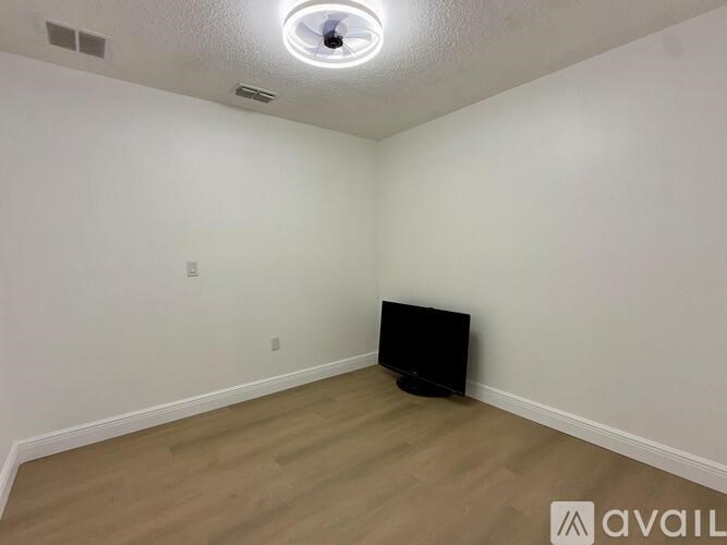 A room with a flat screen TV on the wall.