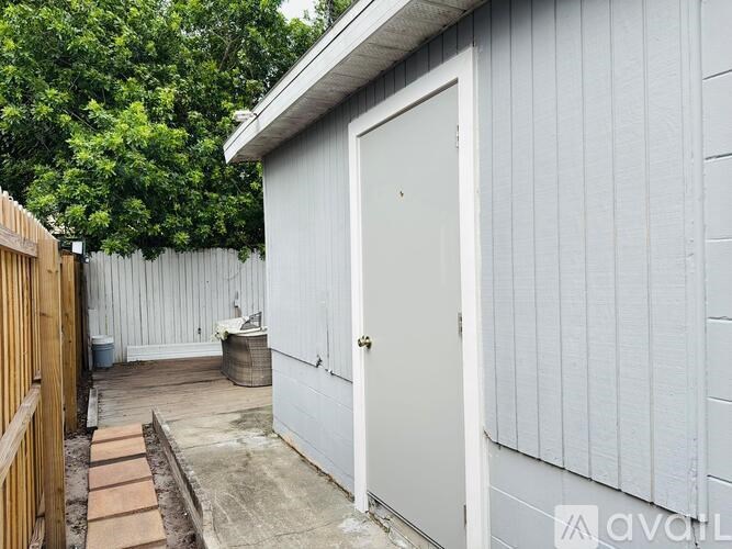 A white door is on the side of a building.