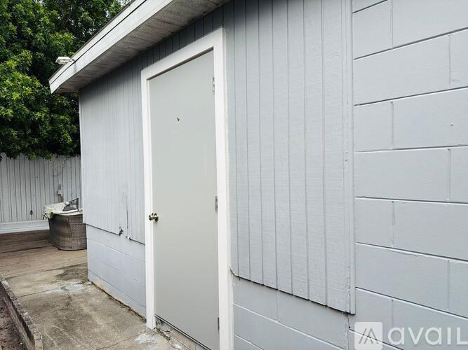 A white door is on a white building.