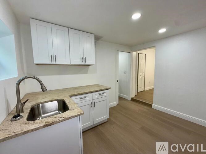 A kitchen with a sink and cabinets.