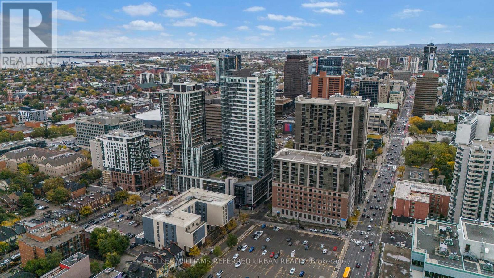 A cityscape with a mix of modern and older buildings, with a clear sky above.
