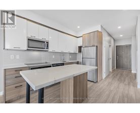 A modern kitchen with white cabinets and a central island.