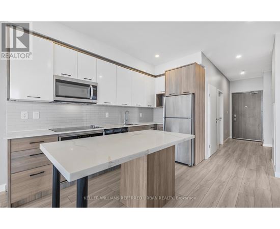 A modern kitchen with white cabinets and a central island.