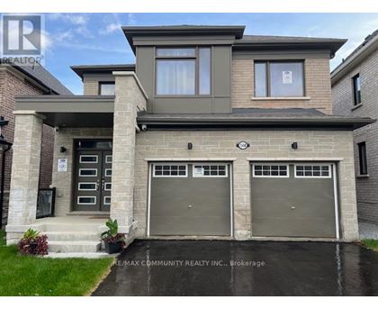 A two-story house with a garage is for sale.