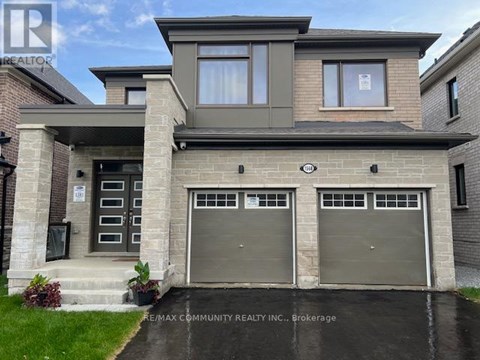 A two-story house with a garage is for sale.