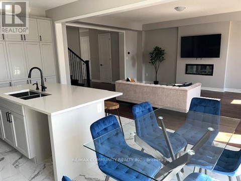 A modern kitchen with blue chairs and a white countertop.