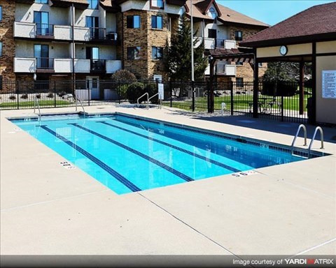 a swimming pool in front of an apartment building