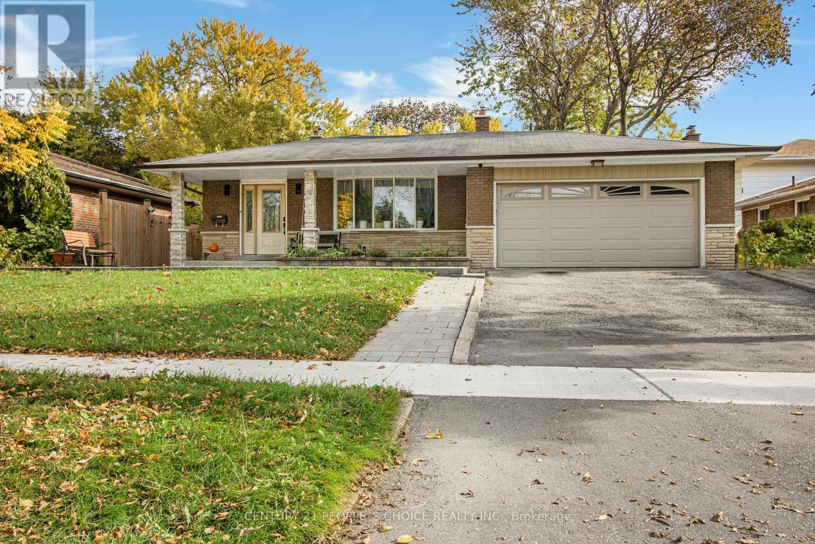 A house with a garage and a driveway in front.