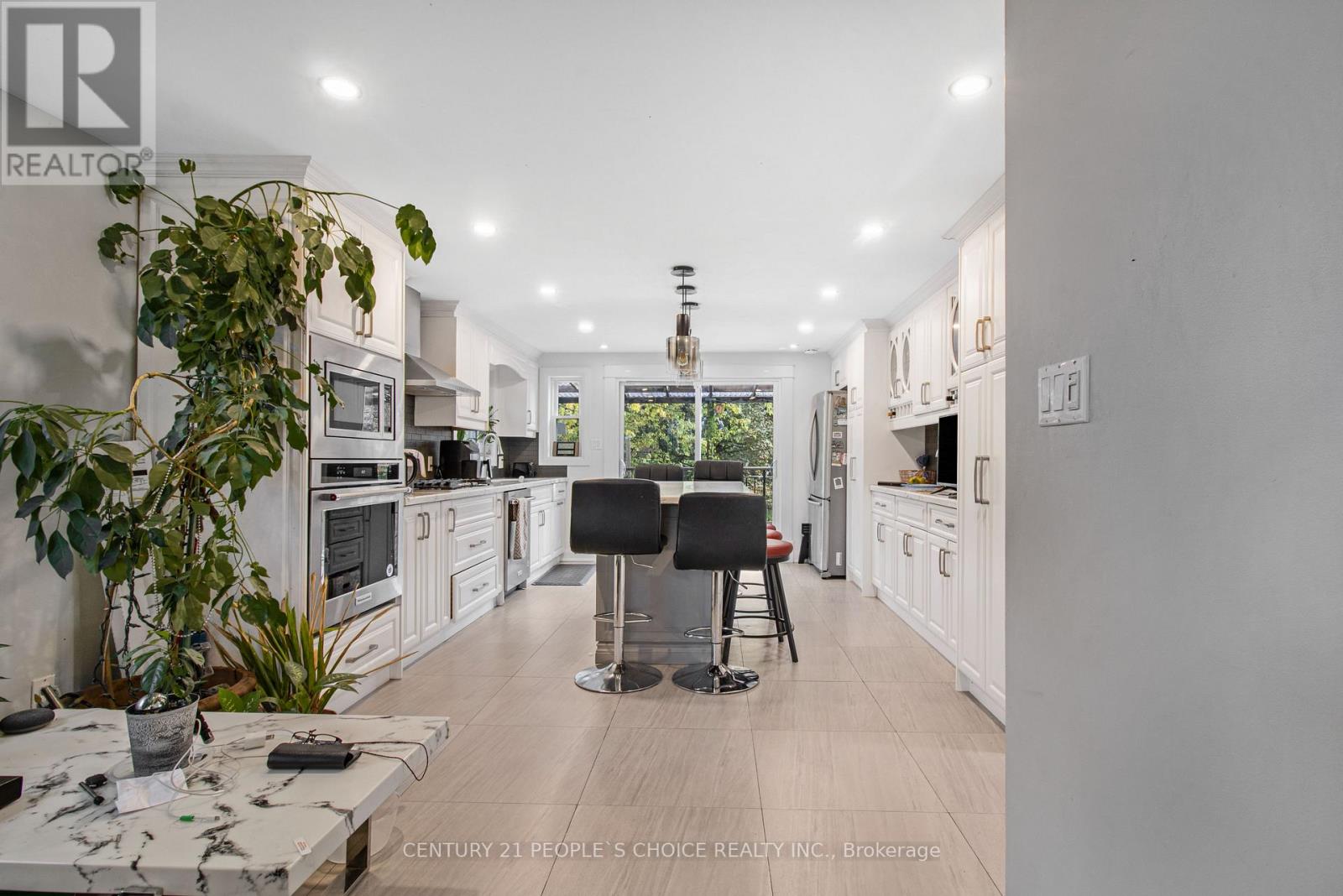 A modern kitchen with white cabinets and a large island.