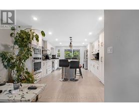 A modern kitchen with white cabinets and a large island.
