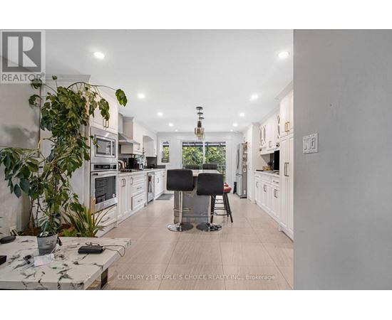 A modern kitchen with white cabinets and a large island.