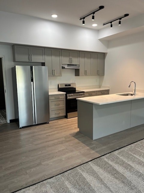 A modern kitchen with a refrigerator, sink, and cabinets.