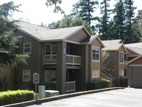 Apartment complex with a parking sign in front.