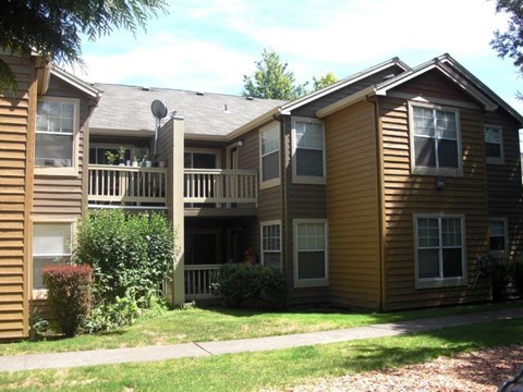A brown house with a white door and windows.