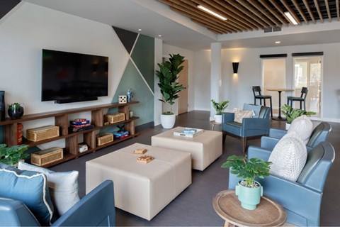A living room with a flat screen TV mounted on the wall.