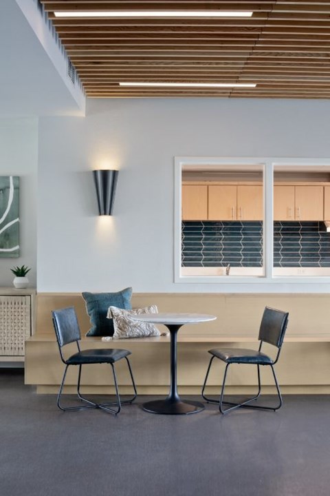 A modern dining area with a table and two chairs.