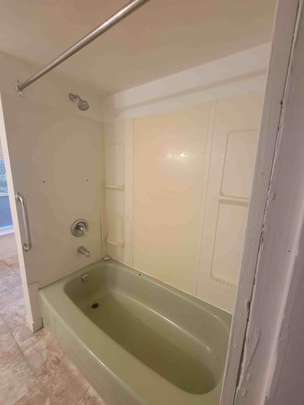 A bathroom with a tub and a shower.