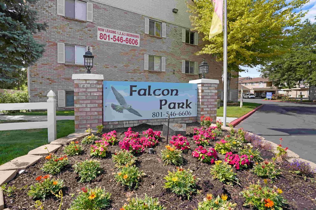 A sign for Falcon Park with a phone number on it.