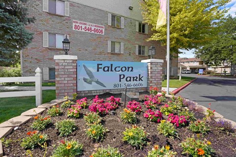 A sign for Falcon Park with a phone number on it.